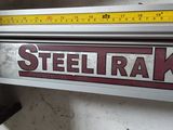 a metal sign that says steeltrak on the side of a building