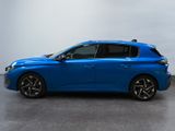 the blue car is parked on the concrete floor in the room