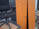 a desk with a chair and a cabinet in a room