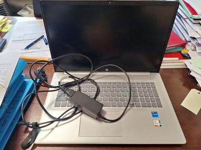 a laptop computer sitting on top of a wooden desk