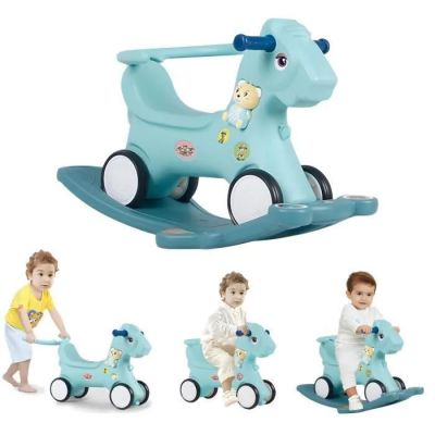 a small child riding a blue rocking horse