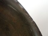 a close up view of a metal object with a sky in the background