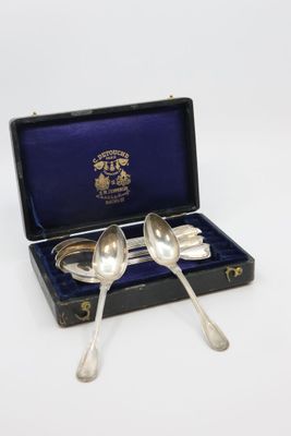 pair of silver plated spoons in a case with blue velvet lining