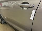 a close up of a car door handle with a sticker on it