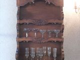 a wooden shelf with wine glasses on it and a chandelier