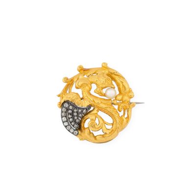 a close up of a gold and diamond broochle on a white background