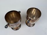 two cups that are sitting on a table
