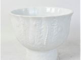 a close up of a white bowl on a table
