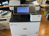 a printer sitting on top of a desk in an office