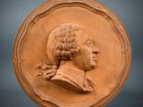 an image of a clay plaque of a man in profile