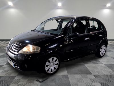 a picture of a small black car parked in a garage