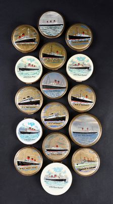 many tins with different designs on them on a black surface