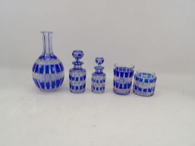 a group of blue glass vases sitting on a table