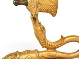 brass figurine of an elephant with a bell on a white background