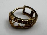 an image of a gold ring on a white surface
