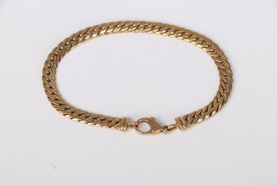 a gold bracelet with a clasp on a white background