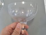 a person holding a wine glass on a table