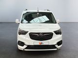 the front view of a white car parked in a showroom