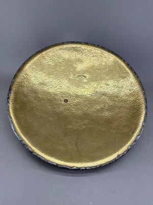 un gros plan d'une plaque dorée posée sur une surface grise