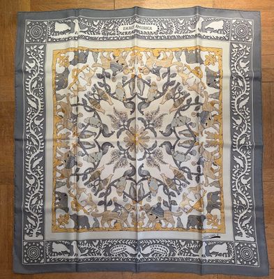 a close up of a square scarf on a wooden floor