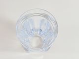 a small clear glass cup with a small white object in it