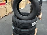 tires stacked on pallets in a warehouse with boxes in the background