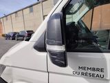 a white van parked in a parking lot next to a building