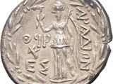 a silver coin with an image of a man holding a sword