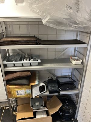 a room with a lot of shelves and boxes on the floor