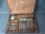 a lot of silverware in a box on a table
