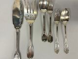 a lot of silver spoons and forks on the table