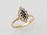 a gold ring with a black diamond and white diamonds