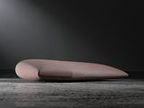 a pink object sitting on the ground under a light