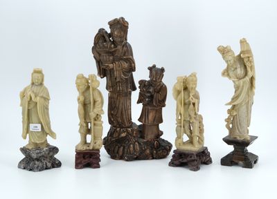 an image of a group of carved figurines sitting on top of a white surface