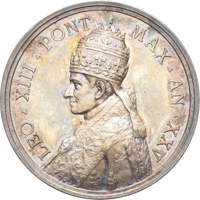 l'image d'une pièce d'argent sur laquelle figure le portrait d'un homme coiffé d'une couronne