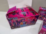 a box of barbie dolls sitting on a table next to other toys