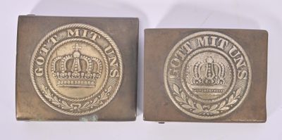 two antique brass belt buckles with a crown on them