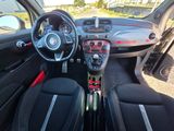 the interior of a small car with black leather seats and a dashboard
