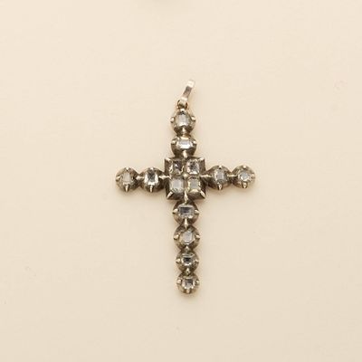 an image of a diamond cross pendant on a white background