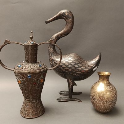 three vases and a bird on a gray background