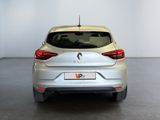 the rear end of a silver car in a white room