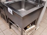 a stainless steel sink in the middle of a kitchen