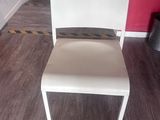 a white chair sitting in a room with a red wall