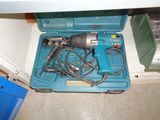 a blue tool box with a drill and other tools in it