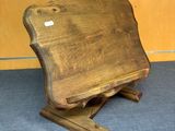 a wooden chair that is sitting on a blue carpet