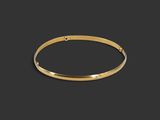 a gold bang bracelet on a black background