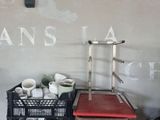 a stack of books sitting on a desk next to a chair