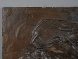 a metal plaque with a horse and a dog on it