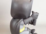 a small toy of a batman sitting on the ground