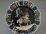 a plate with a picture of a man on a horse